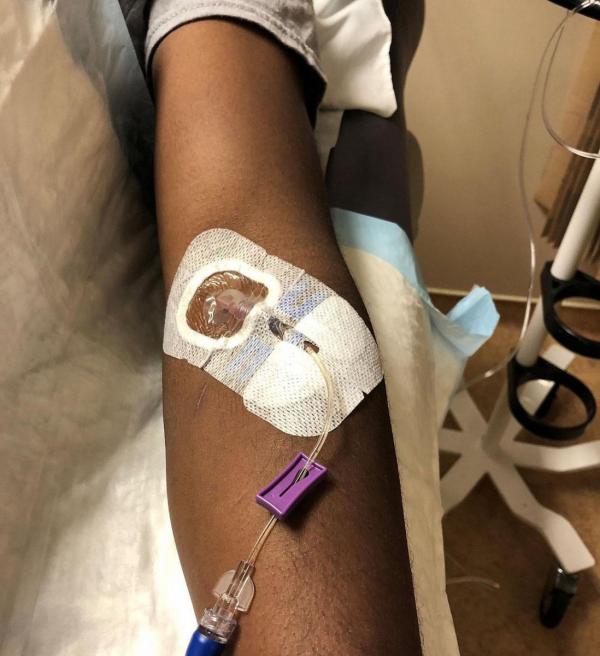 a volunteer receives an infusion of an experimental Ebola therapy during a phase I clinical trial